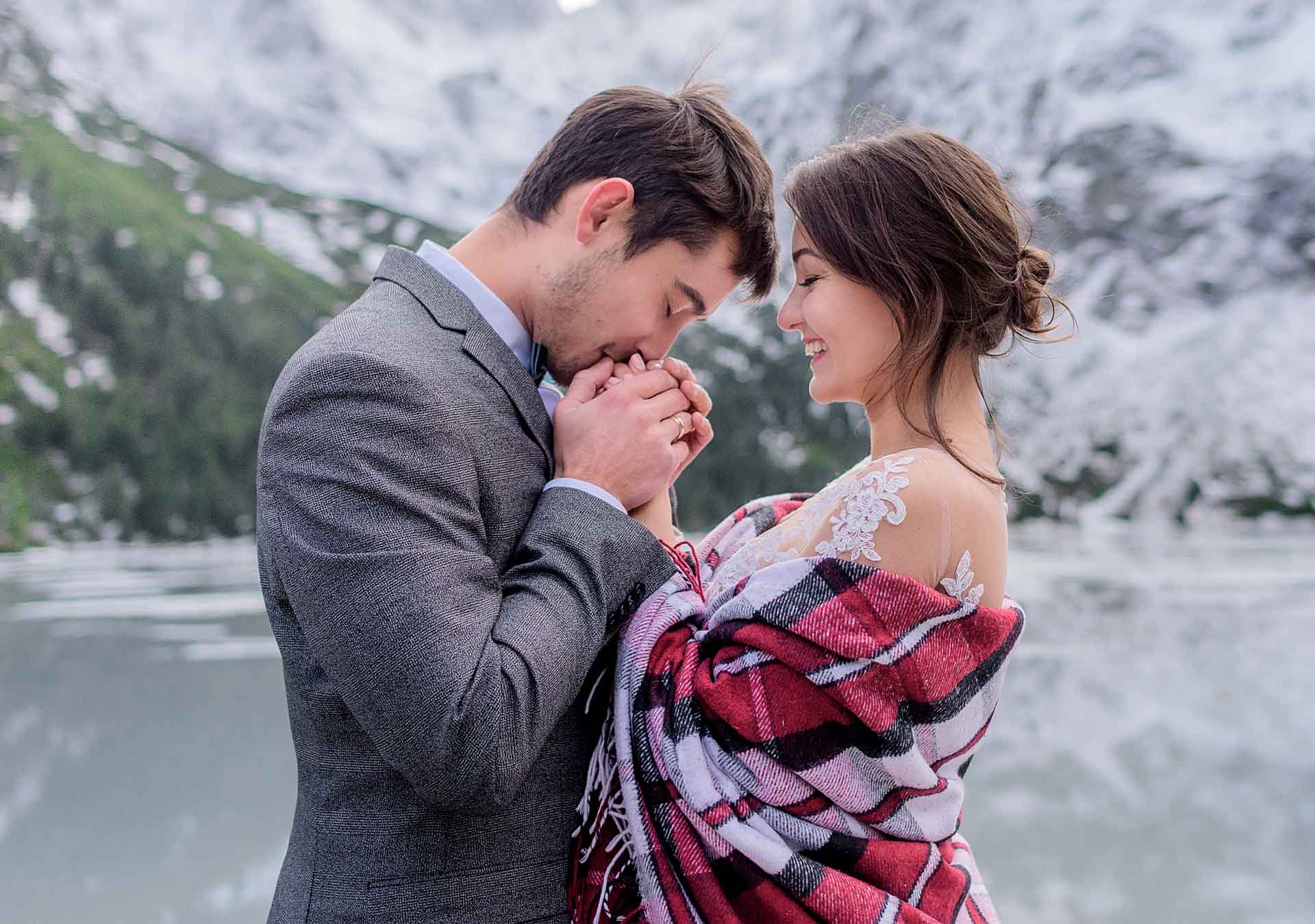 A couple sharing a tender moment against a Himalayan backdrop